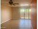 Living space with tan tiling and sliding door to outside with decorative metal bars at 9708 W Redwood Dr, Sun City, AZ 85351