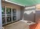 Cozy patio area featuring wrought iron security doors, sun shade, and decorative stone accents at 9708 W Redwood Dr, Sun City, AZ 85351