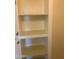 Open shelving unit with decorative patterned shelf liners at 9708 W Redwood Dr, Sun City, AZ 85351