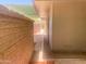 Exterior view showcasing the brick wall and covered patio of the home at 9708 W Redwood Dr, Sun City, AZ 85351