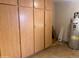Utility room with multiple storage cabinets and a water heater at 9708 W Redwood Dr, Sun City, AZ 85351