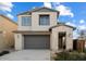 Charming two-story home featuring a two-car garage, stone accents, and well-maintained landscaping at 10013 E Trent Ave, Mesa, AZ 85212