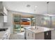 Bright kitchen with a center island and sliding glass doors leading to the backyard at 10013 E Trent Ave, Mesa, AZ 85212