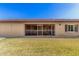 Low-maintenance backyard featuring a covered patio, lawn, and window looking into the home at 11360 E Keats Ave # 92, Mesa, AZ 85209
