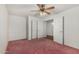 Bedroom featuring neutral walls, ceiling fan, carpet, and a double-door closet for storage at 11360 E Keats Ave # 92, Mesa, AZ 85209