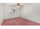 Bedroom with bright natural light, ceiling fan, and neutral walls and carpet at 11360 E Keats Ave # 92, Mesa, AZ 85209