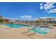 Sparkling community pool with lounge chairs and shade umbrellas for relaxing poolside at 11360 E Keats Ave # 92, Mesa, AZ 85209