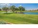 Expansive green golf course with a picturesque pond, fountain, and trees under a clear blue sky at 11360 E Keats Ave # 92, Mesa, AZ 85209