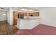 A well-lit kitchen features wooden cabinets and a breakfast bar, creating a warm and inviting space at 11360 E Keats Ave # 92, Mesa, AZ 85209
