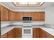 A close-up view of the kitchen showcasing white appliances and wooden cabinets, offering both style and functionality at 11360 E Keats Ave # 92, Mesa, AZ 85209