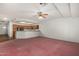 Open living room showcasing carpet, white walls, and a view of the kitchen at 11360 E Keats Ave # 92, Mesa, AZ 85209