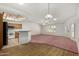 Open living room showcasing carpet, wood flooring, natural light, and access to the kitchen at 11360 E Keats Ave # 92, Mesa, AZ 85209
