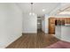 Open floor plan showcasing wood flooring, white walls, and a view of the kitchen at 11360 E Keats Ave # 92, Mesa, AZ 85209