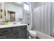 Clean bathroom boasts gray vanity, white countertop, and combination tub/shower at 12211 W Hide Trl, Peoria, AZ 85383
