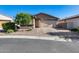 Charming single-story home featuring a two-car garage and a well-maintained desert landscape at 12211 W Hide Trl, Peoria, AZ 85383