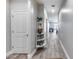 Entryway hallway features modern decor, light colored walls and trim, and wood-look floors at 12211 W Hide Trl, Peoria, AZ 85383