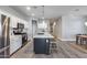 Modern kitchen features white cabinets, a center island, and stainless steel appliances at 12211 W Hide Trl, Peoria, AZ 85383