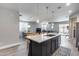 Open floor plan with kitchen island flows into dining and living areas at 12211 W Hide Trl, Peoria, AZ 85383