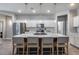 Bright eat-in kitchen featuring a large center island with bar seating and pendant lights at 12211 W Hide Trl, Peoria, AZ 85383