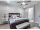 Well-lit main bedroom featuring a king bed, modern decor, and ensuite access at 12211 W Hide Trl, Peoria, AZ 85383