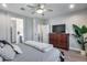 Comfortable main bedroom with hardwood floors, flat screen TV and ensuite access at 12211 W Hide Trl, Peoria, AZ 85383