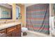Bathroom features granite counters, wooden cabinets, plus a tub and shower combo at 12826 W Maplewood Dr, Sun City West, AZ 85375