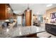 Kitchen with granite countertops open to dining area with lots of light at 12826 W Maplewood Dr, Sun City West, AZ 85375
