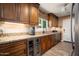Kitchen with stainless steel appliances, wine cooler and granite countertops at 12826 W Maplewood Dr, Sun City West, AZ 85375
