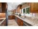 Kitchen with stainless appliances, granite countertops, and double basin sink at 12826 W Maplewood Dr, Sun City West, AZ 85375