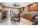 Cozy eat-in kitchen with custom cabinets, wood-look tile floors, and natural light at 12826 W Maplewood Dr, Sun City West, AZ 85375