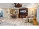 Living room featuring a decorative ceiling fan, wood-look tile floors, and built-in shelving at 12826 W Maplewood Dr, Sun City West, AZ 85375