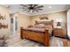 Main bedroom with ensuite bathroom, ceiling fan and wood floors at 12826 W Maplewood Dr, Sun City West, AZ 85375