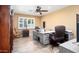 Office featuring hardwood floors, a ceiling fan, a large window, and two office desks at 12826 W Maplewood Dr, Sun City West, AZ 85375