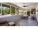 Relaxing screened in patio with wicker furniture and a ceiling fan at 12826 W Maplewood Dr, Sun City West, AZ 85375