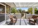 Covered patio with wicker chairs overlooking the landscaped yard at 12826 W Maplewood Dr, Sun City West, AZ 85375