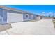 Spacious concrete driveway leads to the home's attached two-car garage providing ample parking at 12938 W Tara Ln, Surprise, AZ 85374