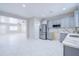 Open concept kitchen featuring stainless steel appliances, grey cabinets, quartz countertops, and stylish flooring at 12938 W Tara Ln, Surprise, AZ 85374
