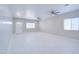Spacious living area featuring new tile flooring, fresh paint, recessed lighting, and ceiling fans at 12938 W Tara Ln, Surprise, AZ 85374
