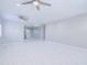 Spacious living room featuring tile floors, neutral walls, and modern ceiling fans at 12938 W Tara Ln, Surprise, AZ 85374
