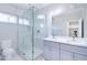 Modern bathroom showcasing a glass-enclosed shower, dual vanity, and stylish fixtures at 12940 W Tara Ln, Surprise, AZ 85374