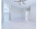 Well-lit bedroom showcasing tiled floors, a ceiling fan, and access to a walk-in closet and hallway at 12940 W Tara Ln, Surprise, AZ 85374