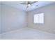 Bedroom with ceiling fan, tile floor, natural light from window at 12940 W Tara Ln, Surprise, AZ 85374