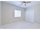 Bedroom featuring tile floors, a ceiling fan, and sliding closet doors at 12940 W Tara Ln, Surprise, AZ 85374