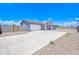 Charming home showcasing a spacious driveway and a well-maintained exterior with a modern design on a sunny day at 12940 W Tara Ln, Surprise, AZ 85374