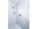 Luxurious shower featuring marble tiles, a rainfall shower head, and a built-in niche at 12940 W Tara Ln, Surprise, AZ 85374