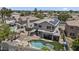 Aerial view of a home with a sparkling pool and solar panels, nestled in a well-maintained neighborhood at 13160 W Windsor Ave, Goodyear, AZ 85395