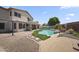 Beautiful backyard with sparkling pool, lush landscaping, and inviting patio area for outdoor entertaining at 13160 W Windsor Ave, Goodyear, AZ 85395
