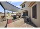 Backyard with outdoor grilling area, featuring a large shade, creating a perfect space for summer gatherings at 13160 W Windsor Ave, Goodyear, AZ 85395