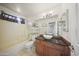 This bathroom features a tub and shower, vessel sink, and neutral color palette at 13160 W Windsor Ave, Goodyear, AZ 85395