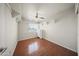 This spare bedroom features a ceiling fan, wood floors, and built-in storage at 13160 W Windsor Ave, Goodyear, AZ 85395